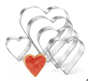 5 heart shaped cookie cutters of varying sizes (larger to small) with one red icing cookie as a display.
