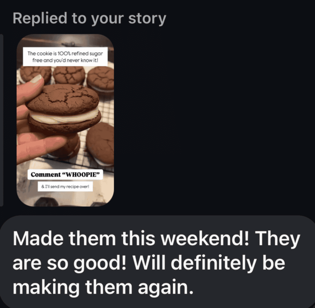 A photo of a hand holding a brown sandwich cookie with cream in the middle and a black text bubble underneath reading Made them this weekend!! They are so good!! Will definitely be making them again.