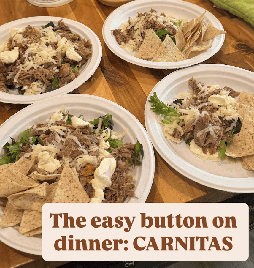 Four white plates with shredded meat, chips, white melted cheese and lettuce. Brown text in a white box that reads The easy button on dinner: CARNITAS in all caps