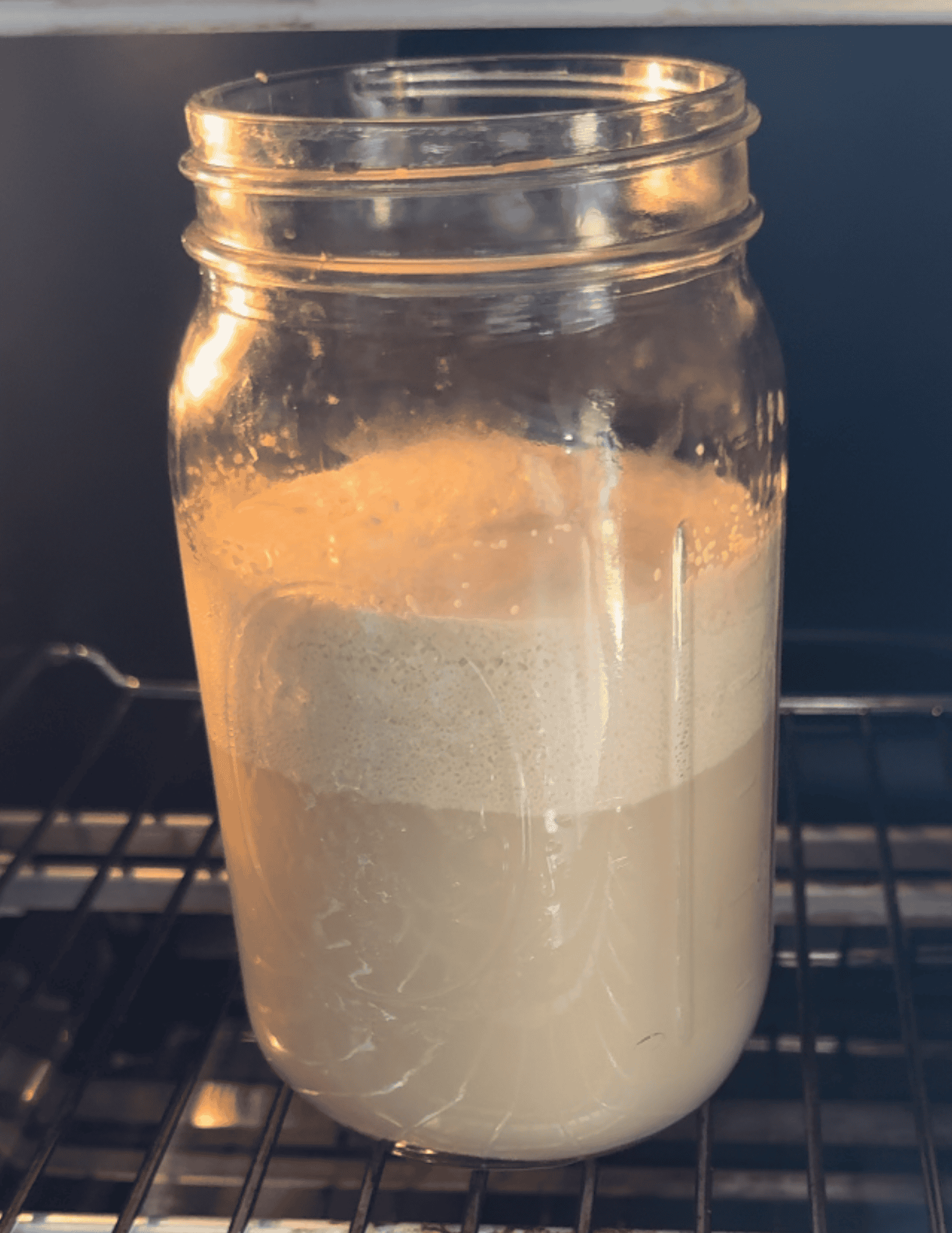 Creamy gluten-free pizza dough in a jar, perfect for soft, fluffy, and chewy crusts.