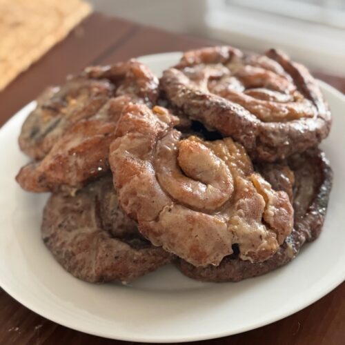 A stack of gluten free honey buns on a white plate.