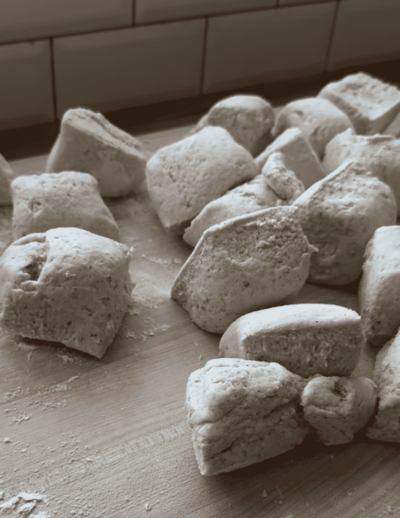 Several balls of raw gluten free pizza dough on a counter